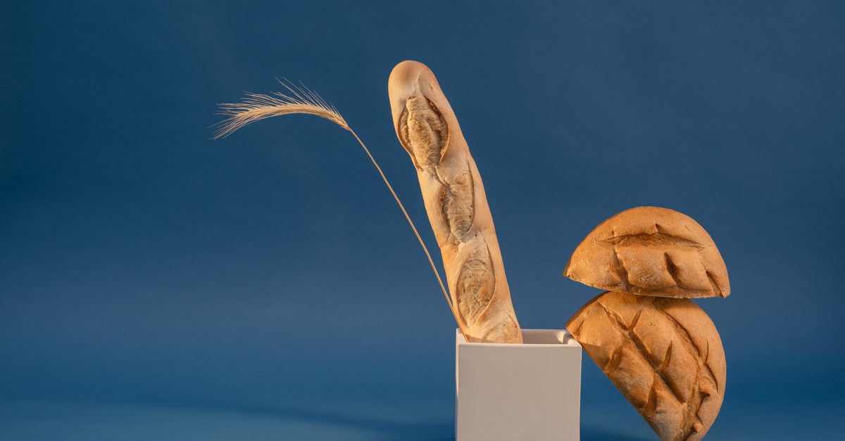 een houten broodtrommel met een half stokbrood erin